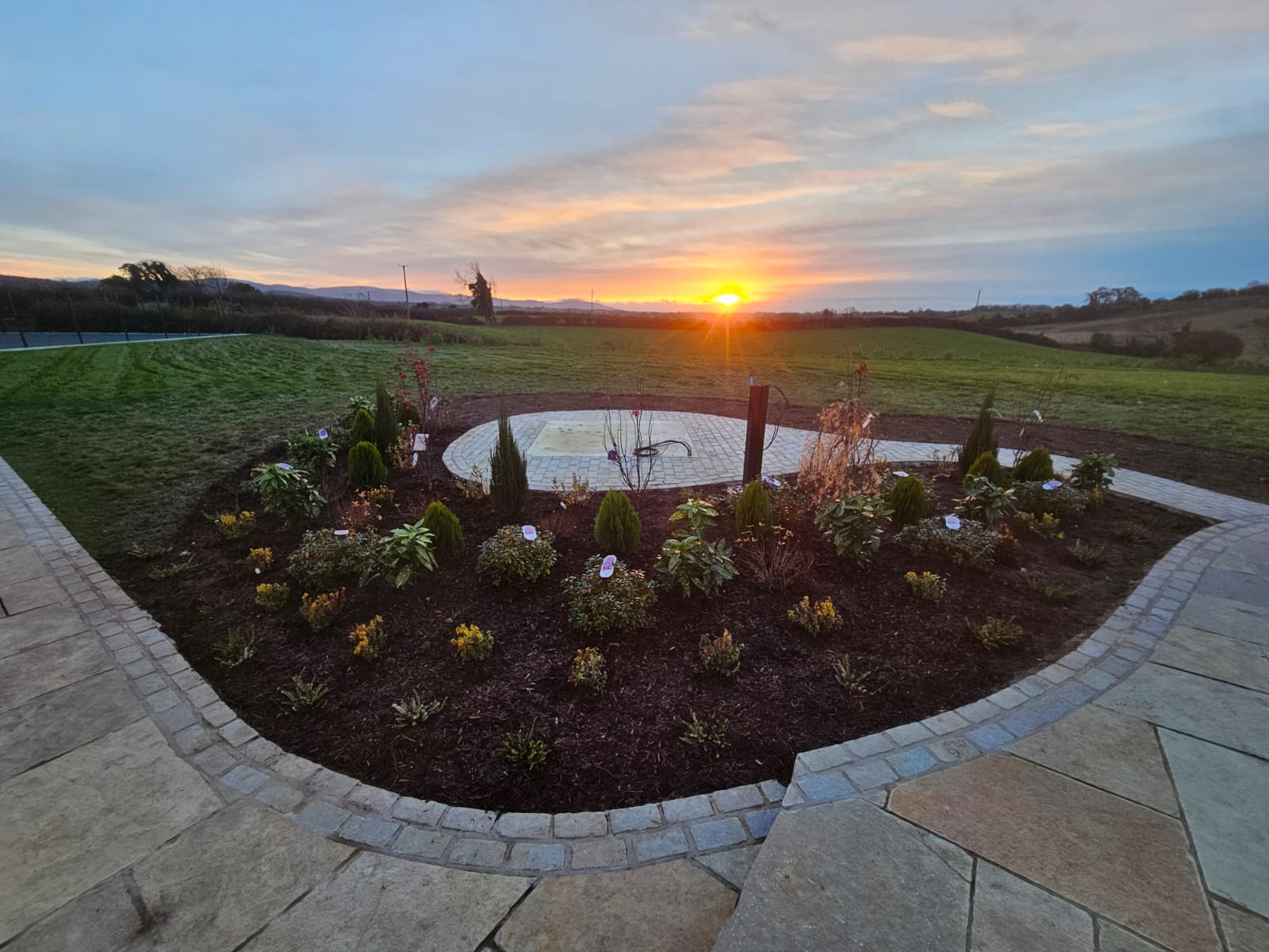 Contemporary garden design with natural stone work at sunset