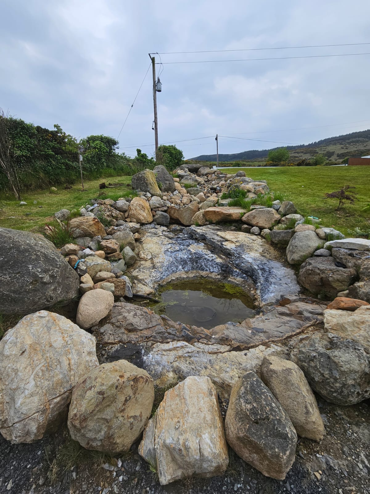 Stunning natural stone water feature with multi-level cascading design