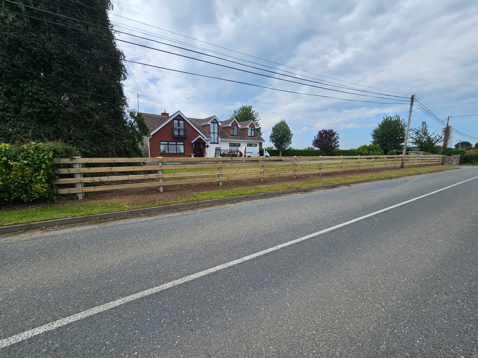 Professional post and rail fencing section with mesh panels